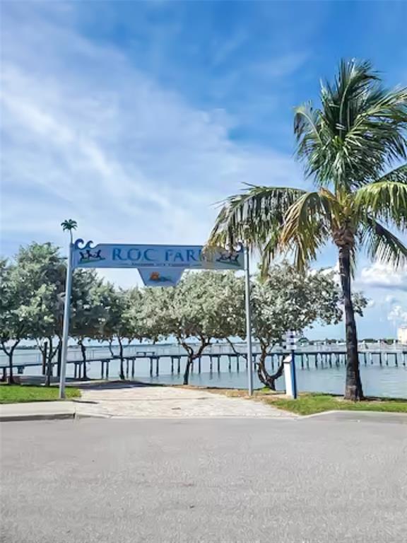 315 Medallion Boulevard, Unit F Madeira Beach, FL 33708 - Photo 16 of 18 a view of swimming pool with a table and chairs