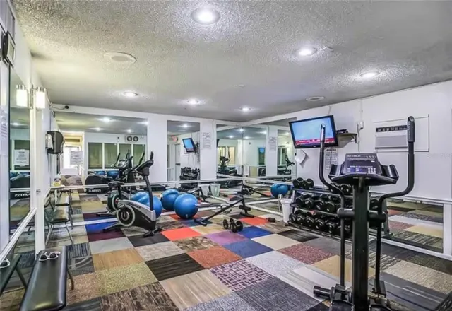 a living room with lots of furniture and a wooden floor