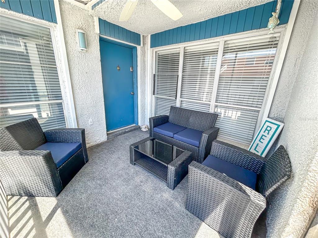 315 Medallion Boulevard, Unit F Madeira Beach, FL 33708 - Photo 2 of 18 a living room with furniture and a window