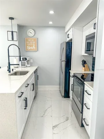 a kitchen with a sink stove and refrigerator