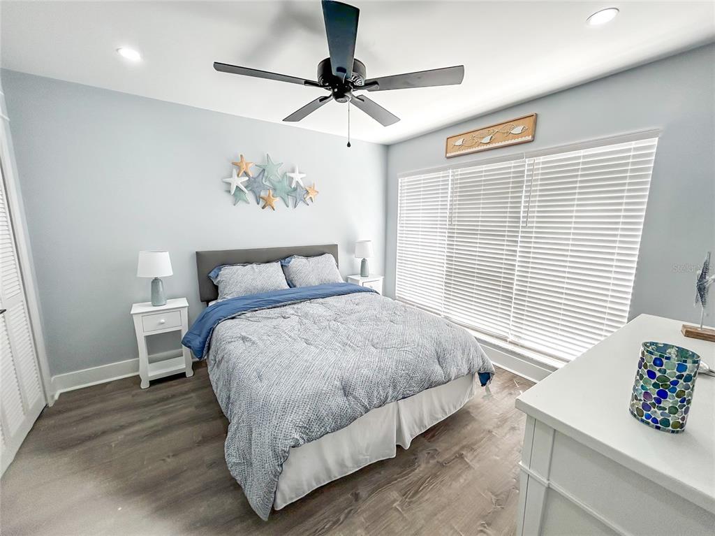 315 Medallion Boulevard, Unit F Madeira Beach, FL 33708 - Photo 10 of 18 a bedroom with a bed and a window