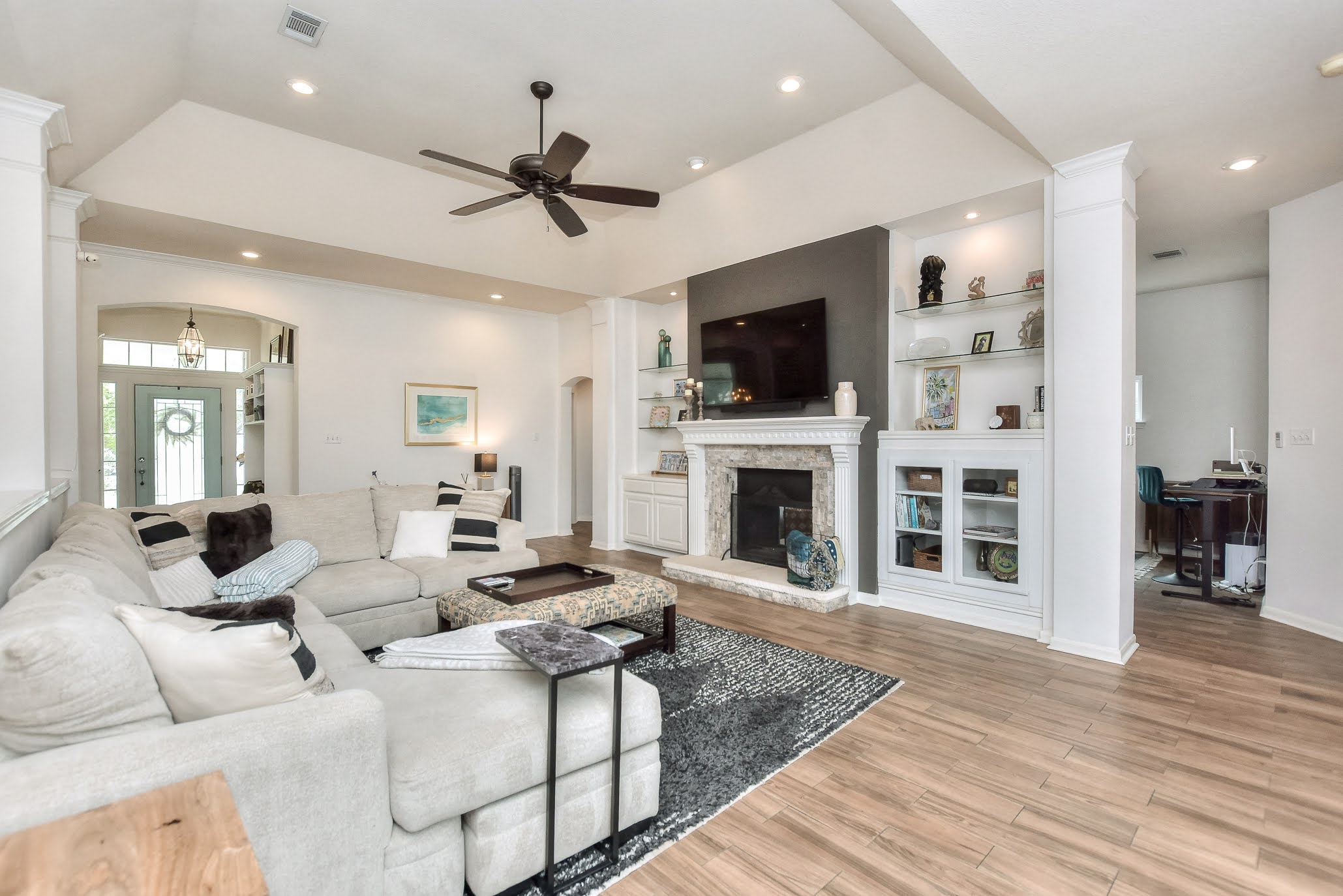 111 Green Grove Georgetown, TX 78633 - Photo 12 of 40 Living area featuring arched walkways, light wood-type flooring, ceiling fan, a fireplace, and recessed lighting