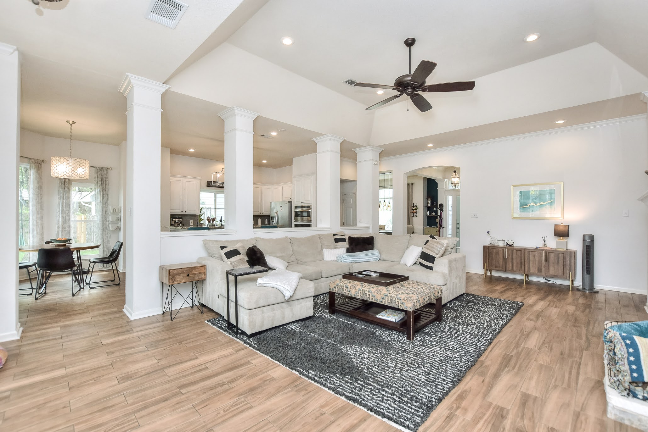 111 Green Grove Georgetown, TX 78633 - Photo 13 of 40 Living room with light wood-type flooring, arched walkways, ceiling fan, ornate columns, and recessed lighting