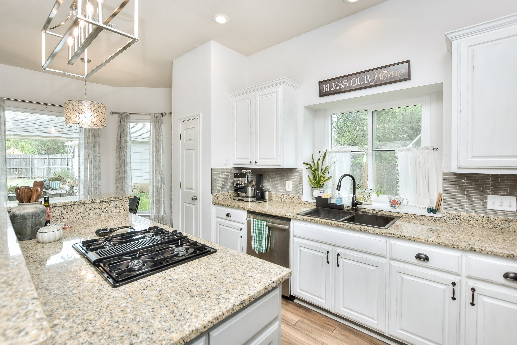 111 Green Grove Georgetown, TX 78633 - Photo 17 of 40 Kitchen featuring white cabinetry, light stone countertops, black gas stovetop, stainless steel dishwasher, and decorative backsplash
