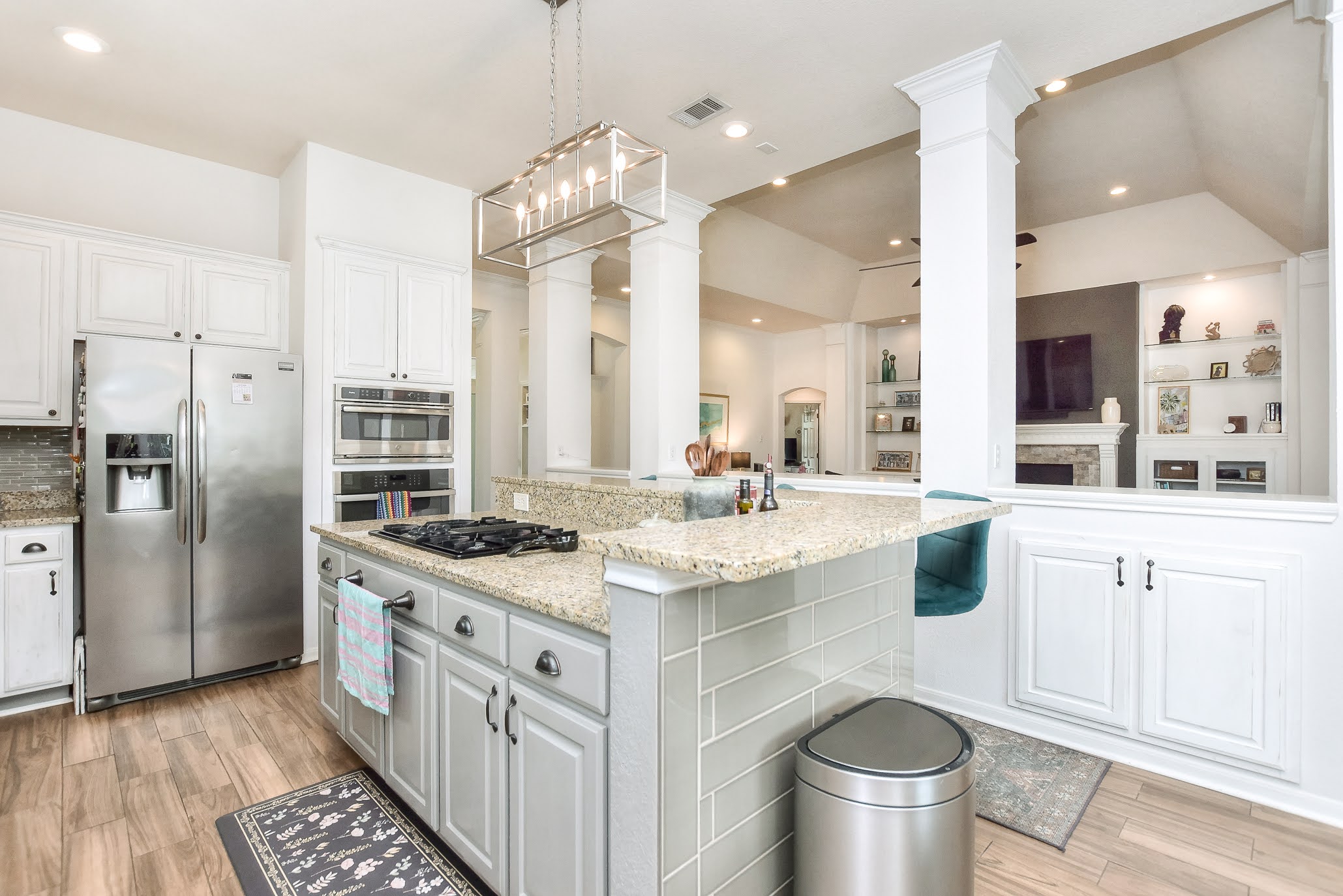 111 Green Grove Georgetown, TX 78633 - Photo 19 of 40 Kitchen with stainless steel appliances, light wood-style floors, white cabinets, and light stone countertops