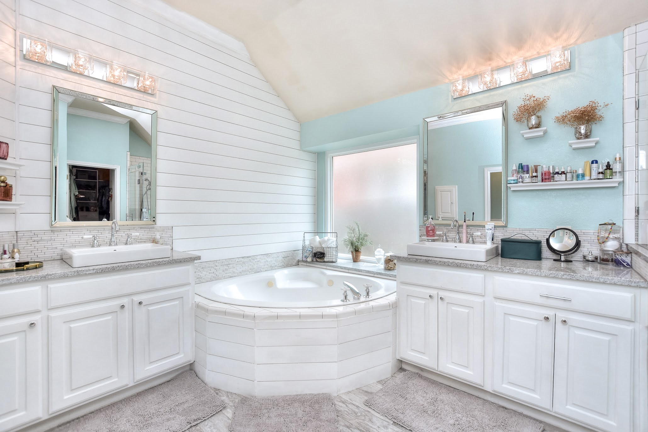 111 Green Grove Georgetown, TX 78633 - Photo 27 of 40 Full bath featuring two vanities, a garden tub, lofted ceiling, and wood walls