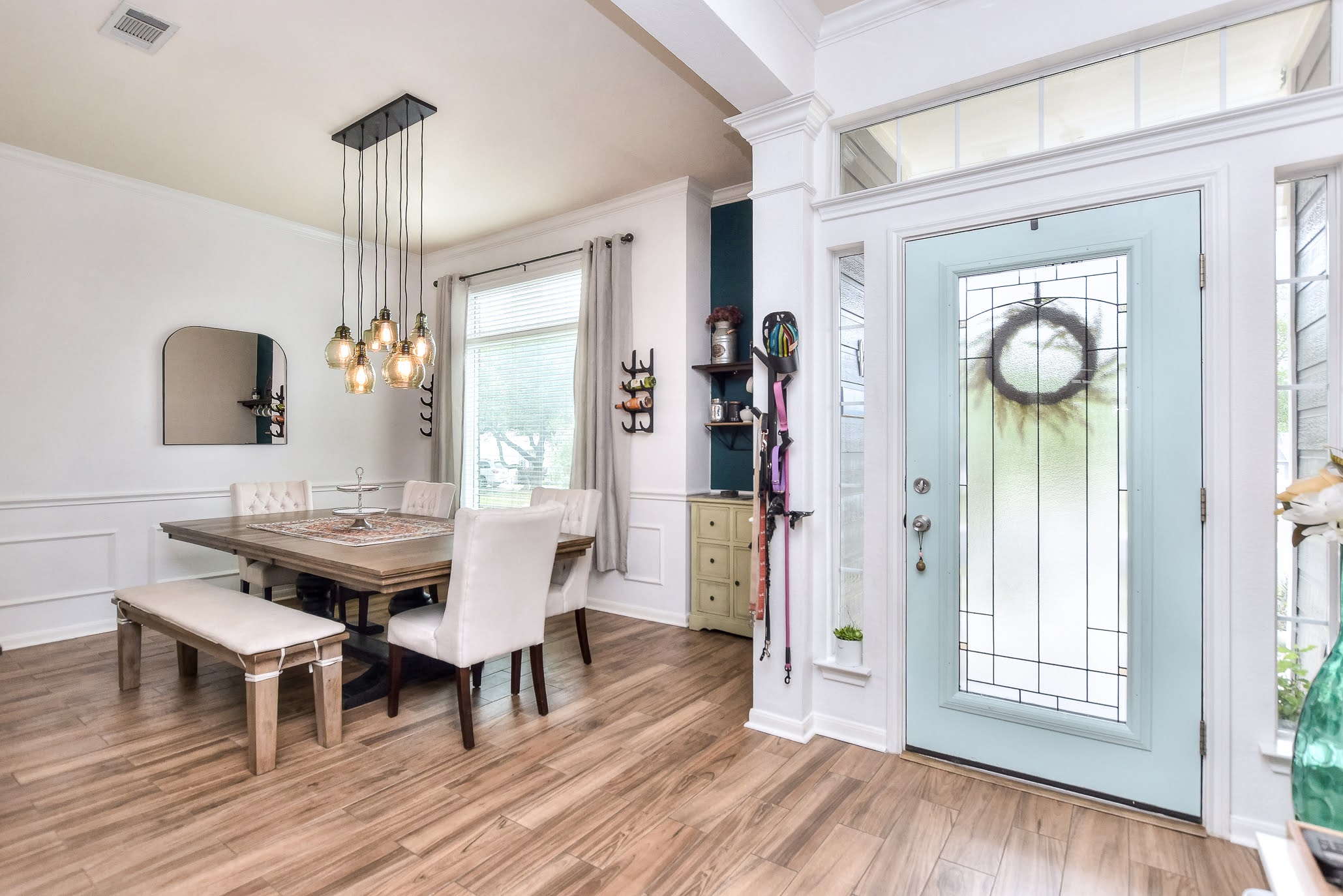 111 Green Grove Georgetown, TX 78633 - Photo 7 of 40 Dining space featuring ornamental molding, light wood-type flooring, a decorative wall, wainscoting, and suspended lighting