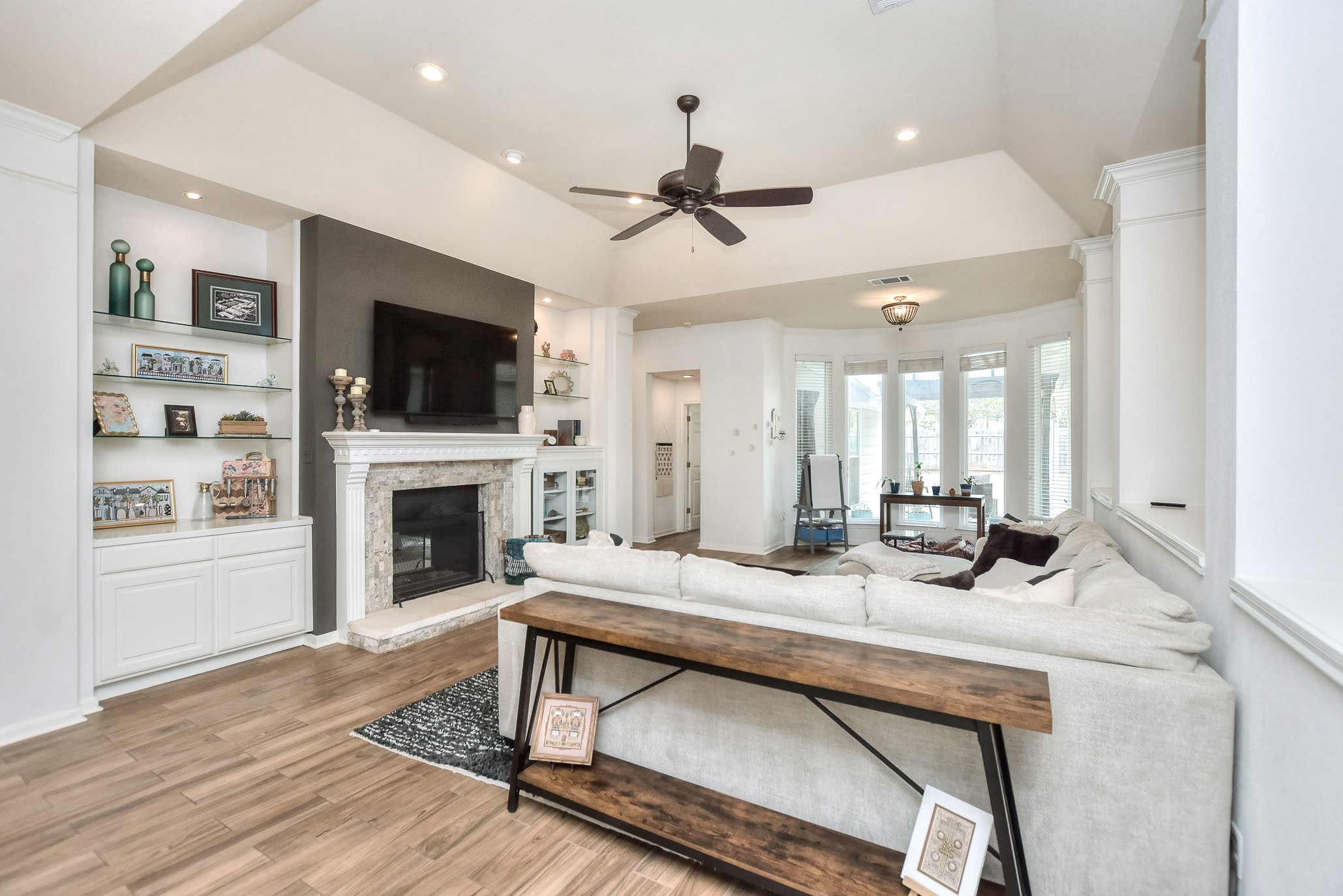 111 Green Grove Georgetown, TX 78633 - Photo 9 of 40 Living room featuring a glass covered fireplace, light wood-type flooring, recessed lighting, ceiling fan, and built in features