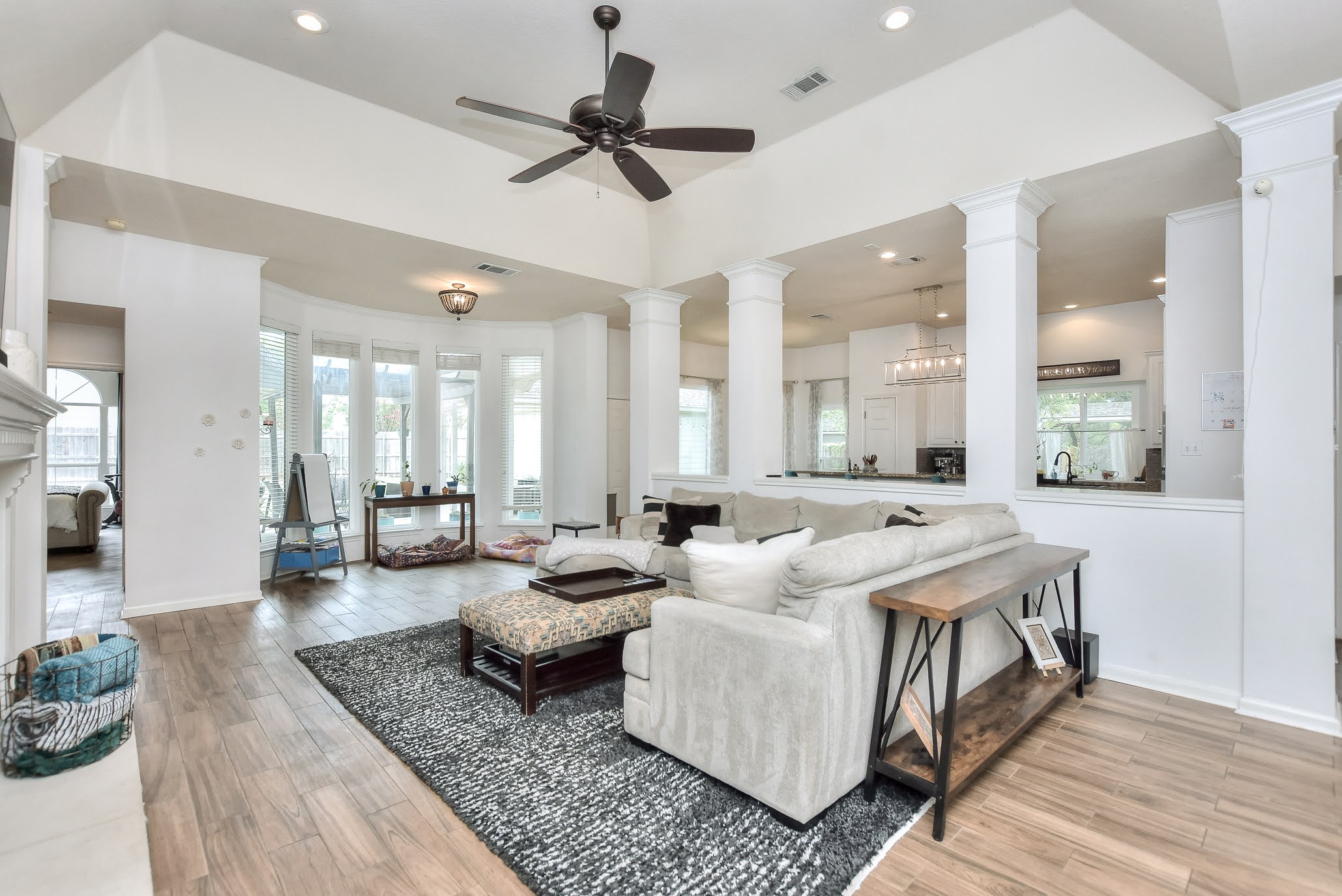 111 Green Grove Georgetown, TX 78633 - Photo 10 of 40 Living area with light wood finished floors, ceiling fan, recessed lighting, and decorative columns