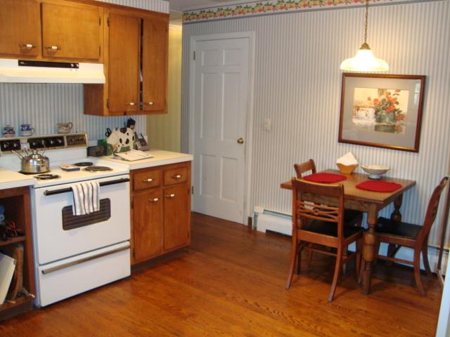 Undisclosed Address New Canaan, CT 06840 - Photo 12 of 14 a kitchen with a stove and a dining table