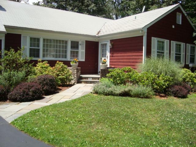 Undisclosed Address New Canaan, CT 06840 - Photo 5 of 14 a front view of a house with a yard