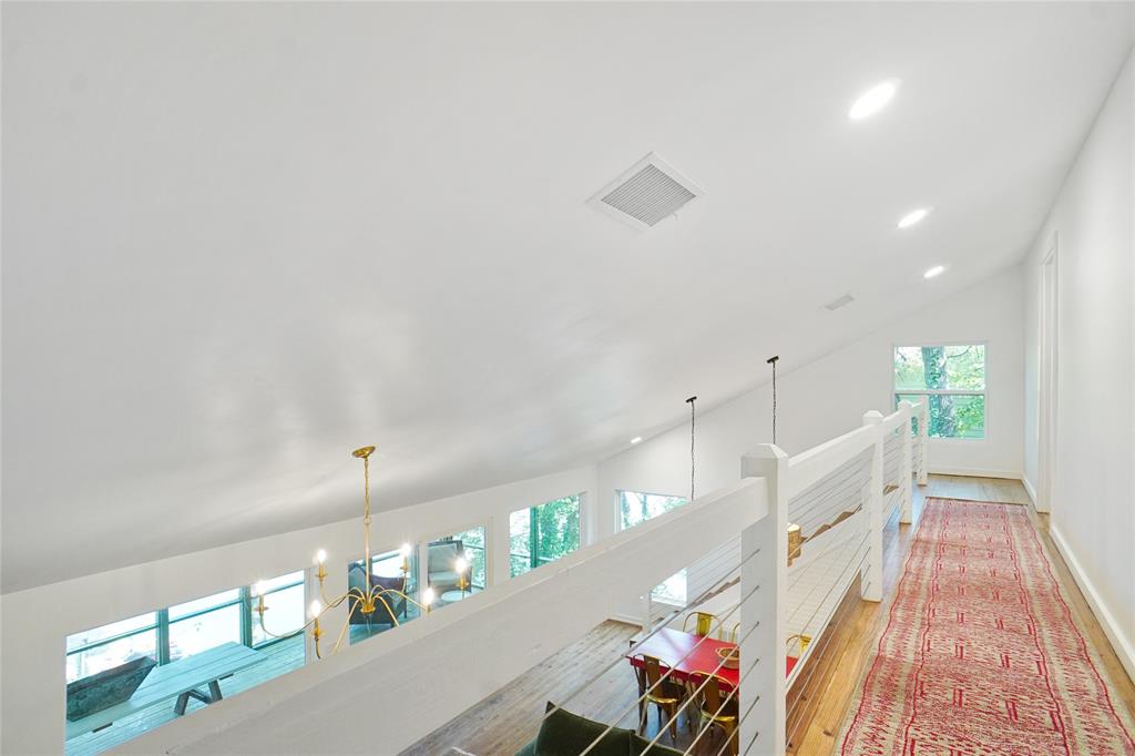 2147 Chaparral Gainesville, TX 76240 - Photo 23 of 40 Hall with vaulted ceiling, light wood-style floors, and hanging lights