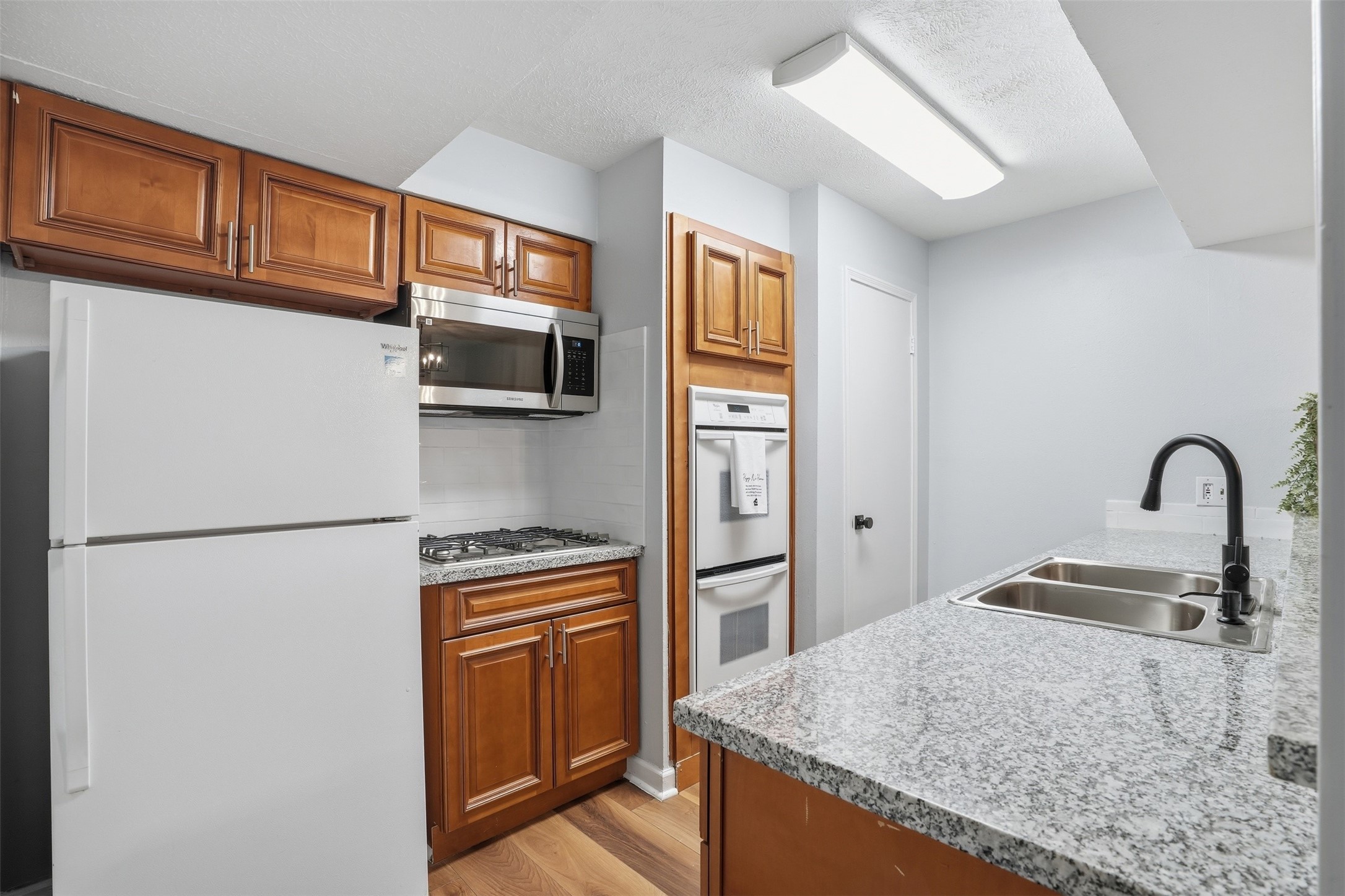 11647 Sabo Road Houston, TX 77089 - Photo 11 of 36 a kitchen with granite countertop a refrigerator and a sink