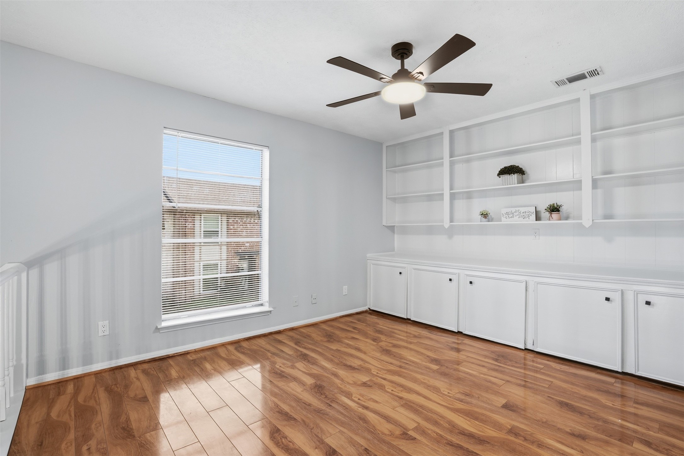 11647 Sabo Road Houston, TX 77089 - Photo 13 of 36 a view of empty room with wooden floor and window