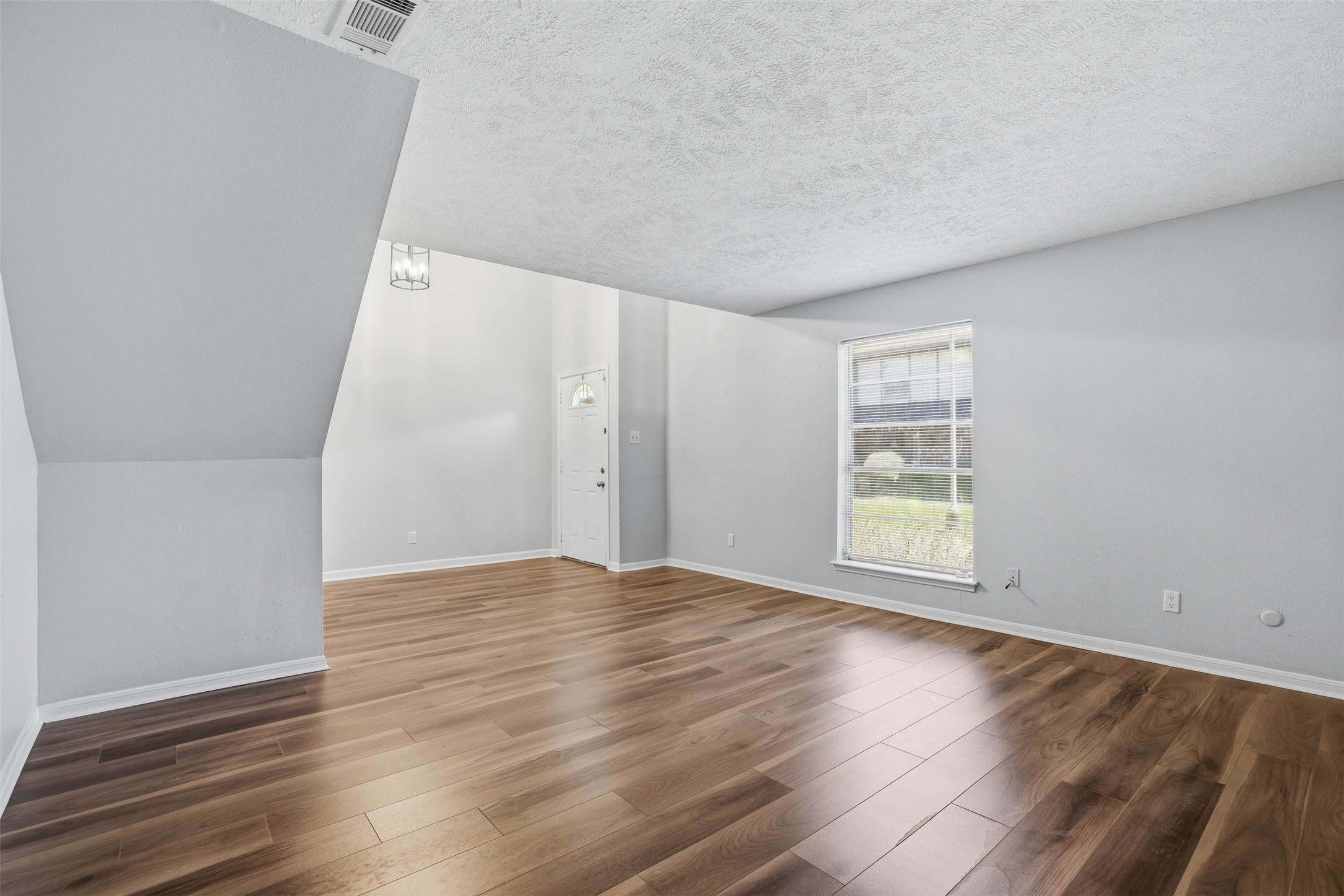 11647 Sabo Road Houston, TX 77089 - Photo 15 of 36 an empty room with wooden floor and windows
