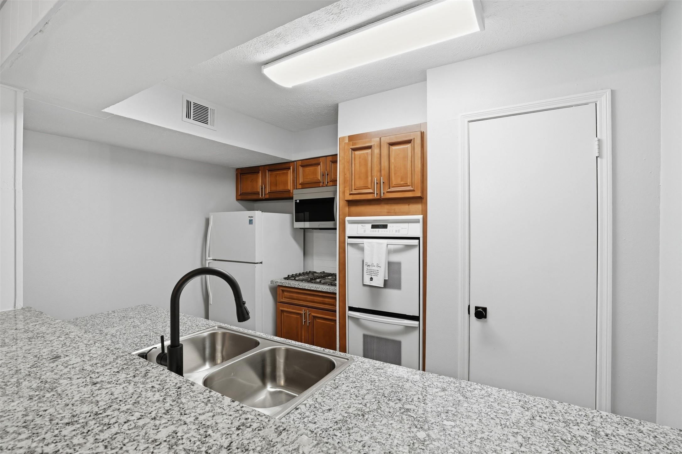 11647 Sabo Road Houston, TX 77089 - Photo 22 of 36 a kitchen with stainless steel appliances kitchen island a refrigerator sink and cabinets