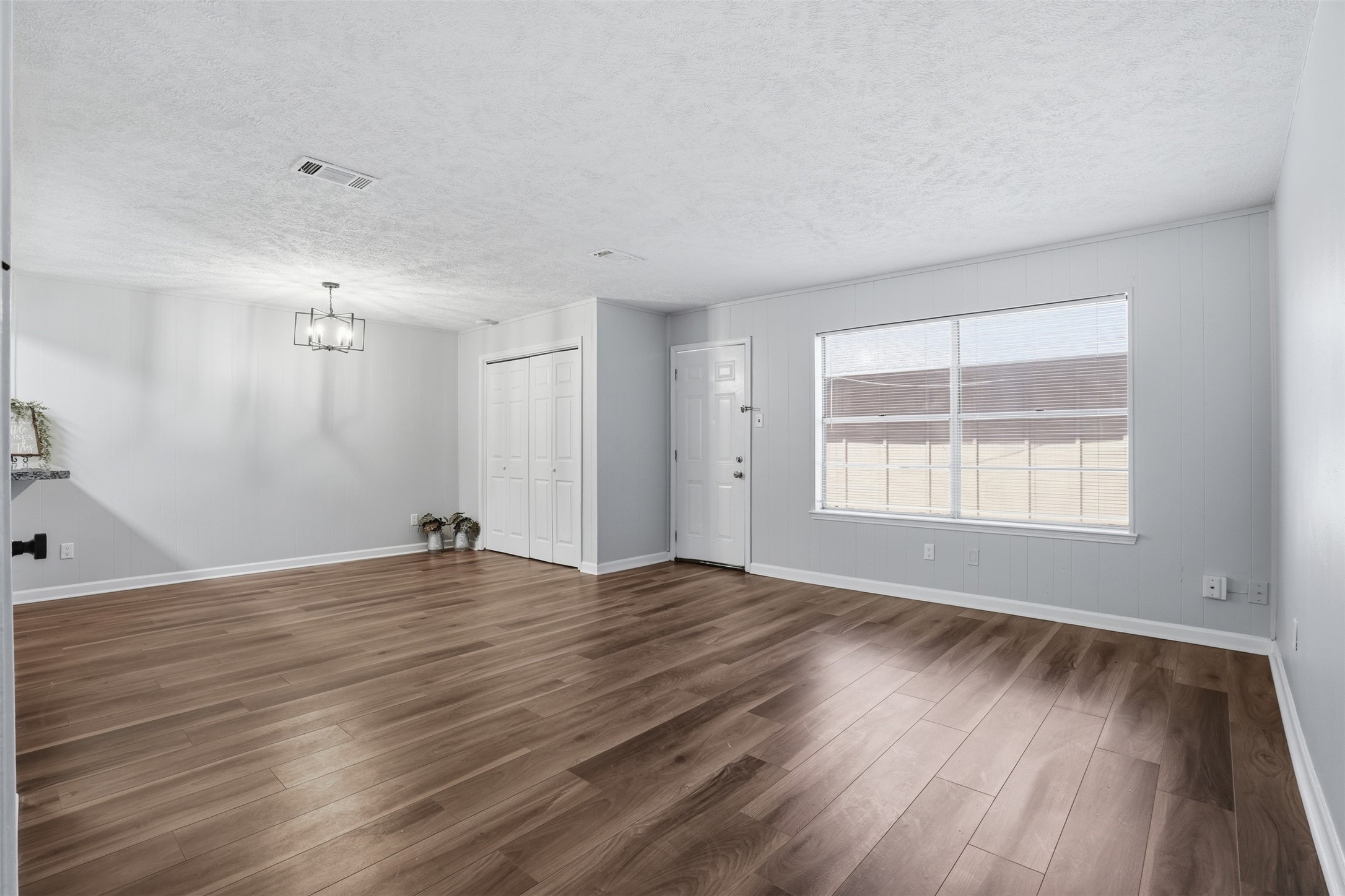 11647 Sabo Road Houston, TX 77089 - Photo 9 of 36 an empty room with wooden floor and windows