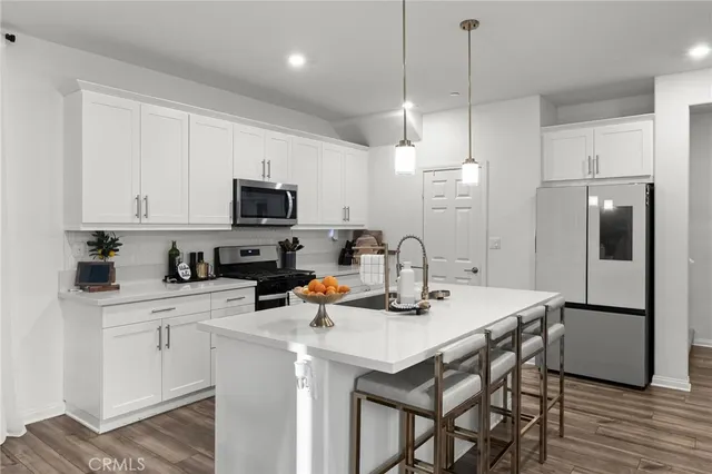 a kitchen with a sink a stove a refrigerator and cabinets