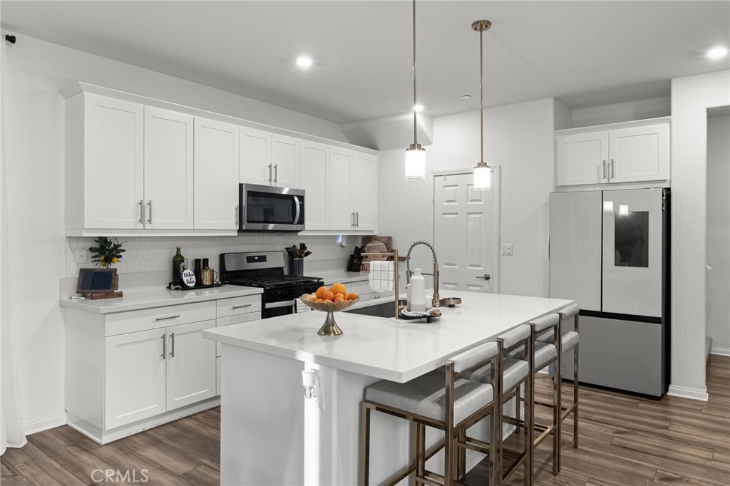 352 Alice Avenue Rialto, CA 92376 - Photo 12 of 41 a kitchen with a sink a stove a refrigerator and cabinets