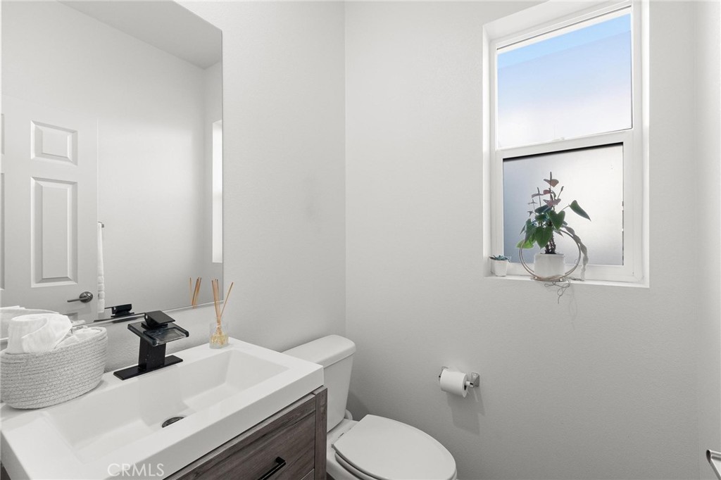 352 Alice Avenue Rialto, CA 92376 - Photo 19 of 41 a bathroom with a sink a toilet and mirror