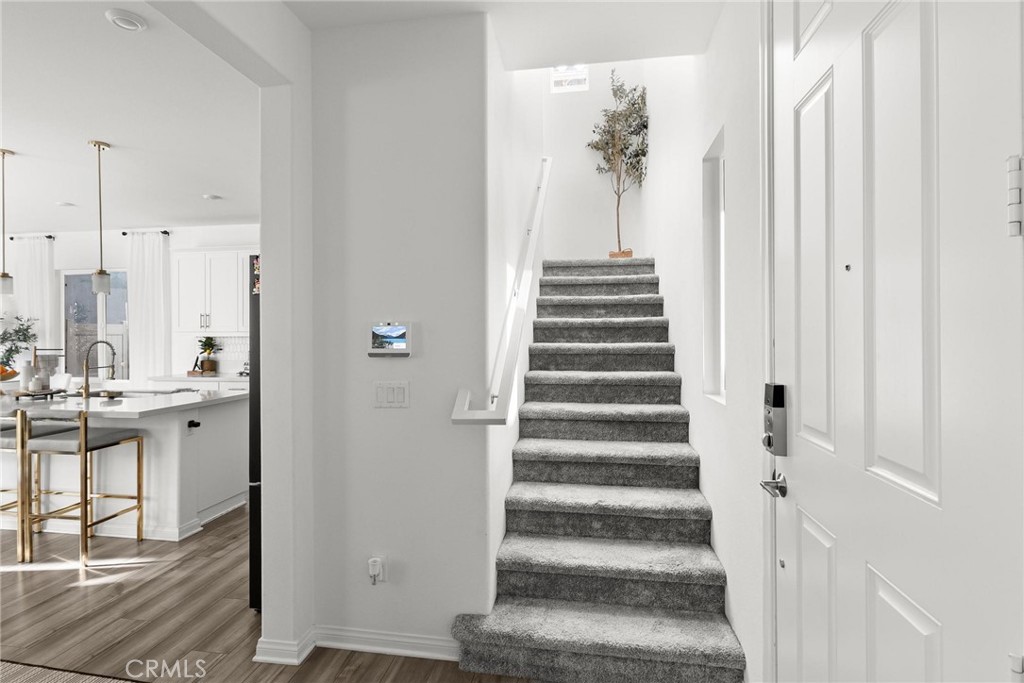 352 Alice Avenue Rialto, CA 92376 - Photo 24 of 41 a view of a hallway with wooden floor and staircase