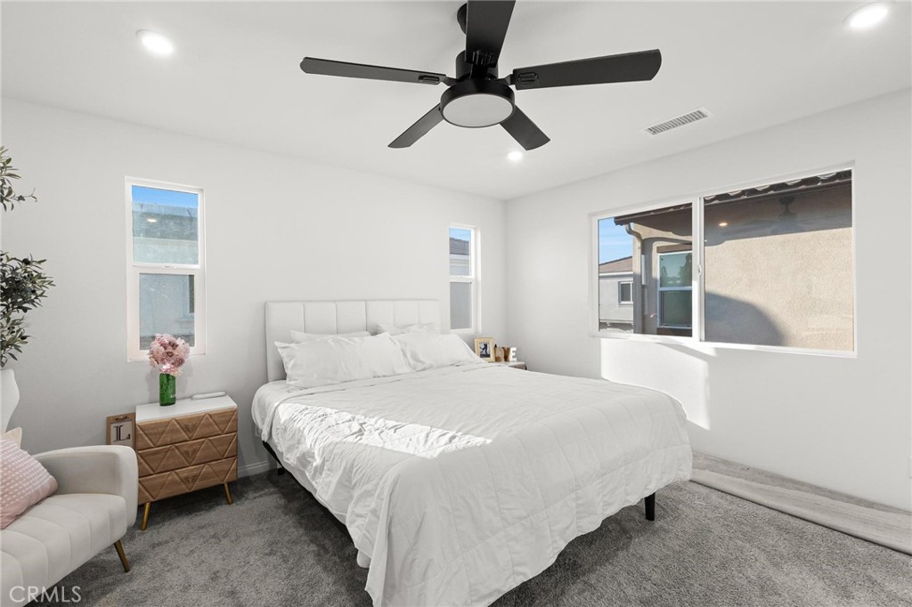 352 Alice Avenue Rialto, CA 92376 - Photo 26 of 41 a bedroom with a bed couch and window