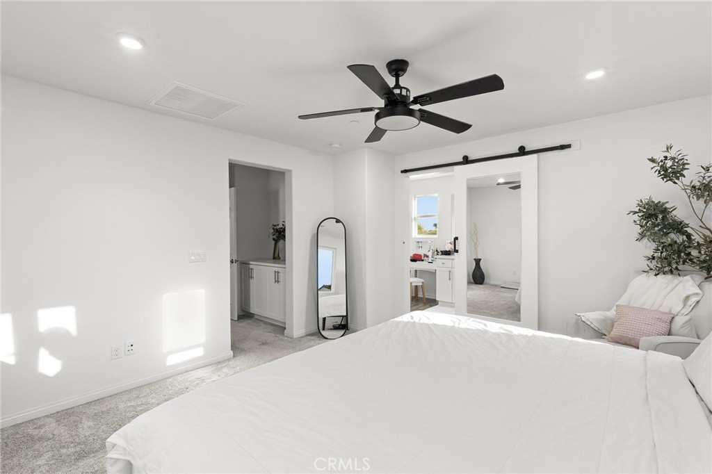 352 Alice Avenue Rialto, CA 92376 - Photo 27 of 41 a bedroom with a bed and a chandelier