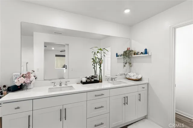 a bathroom with a double vanity sink and mirror
