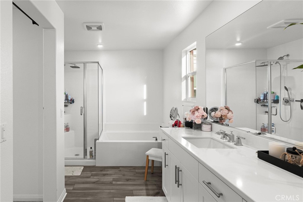 352 Alice Avenue Rialto, CA 92376 - Photo 29 of 41 a bathroom with a double vanity sink a mirror and a bathtub