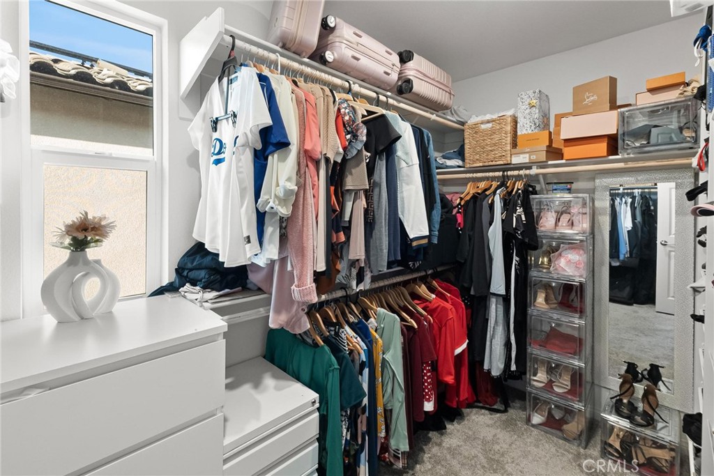 352 Alice Avenue Rialto, CA 92376 - Photo 32 of 41 a view of walk in closet with clothes and shoes