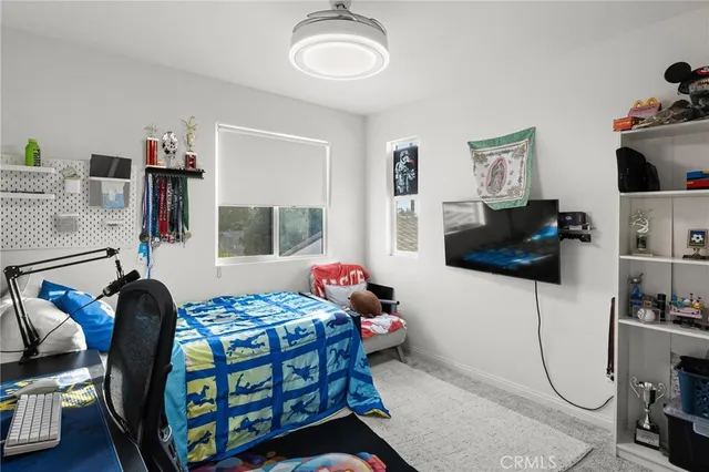 a bedroom with furniture and a window