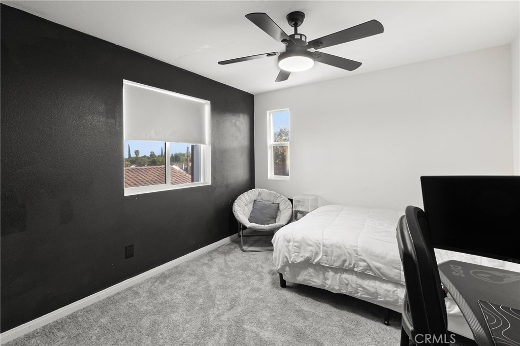 352 Alice Avenue Rialto, CA 92376 - Photo 36 of 41 a bedroom with a bed and a chandelier