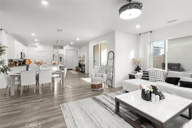 a living room with lots of furniture and kitchen view