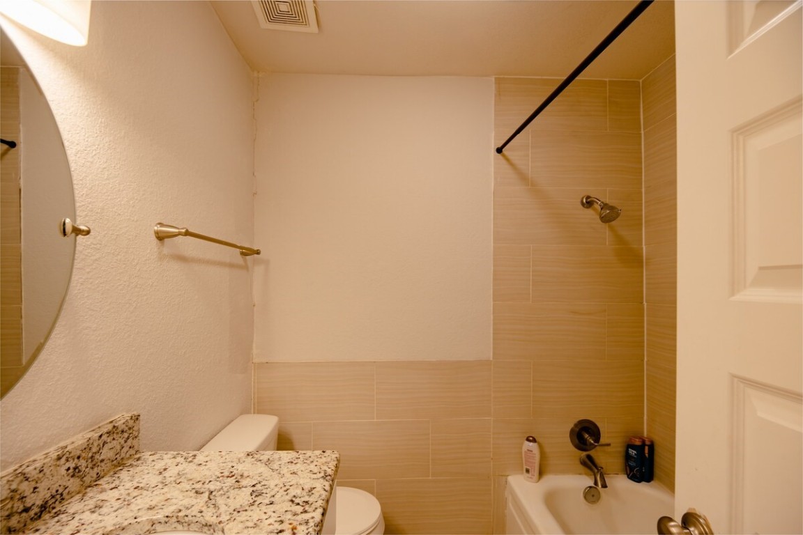 2603 Parker Lane, Unit B Austin, TX 78741 - Photo 15 of 40 a bathroom with a sink and a shower