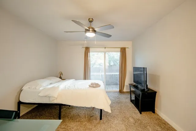 a bedroom with a bed and a flat screen tv