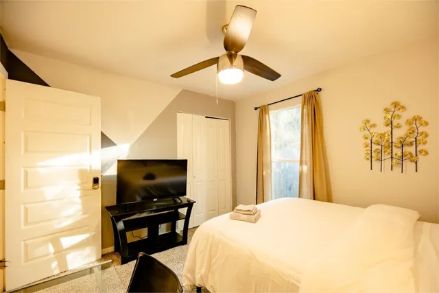 a bedroom with a bed and a flat screen tv