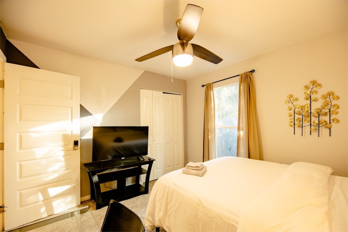 2603 Parker Lane, Unit B Austin, TX 78741 - Photo 17 of 40 a bedroom with a bed and a flat screen tv