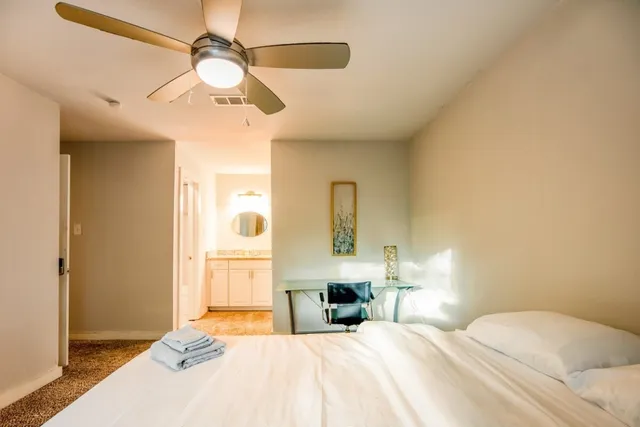 a bedroom with a bed and a chandelier