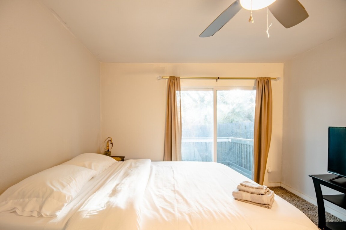 2603 Parker Lane, Unit B Austin, TX 78741 - Photo 27 of 40 a bedroom with a bed and a flat tv screen