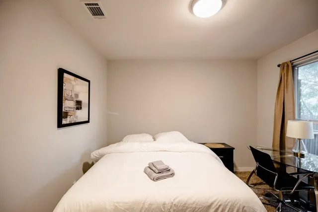 a bedroom with a bed and a table