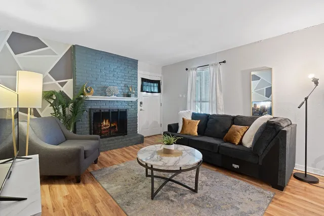 a living room with furniture and a fireplace