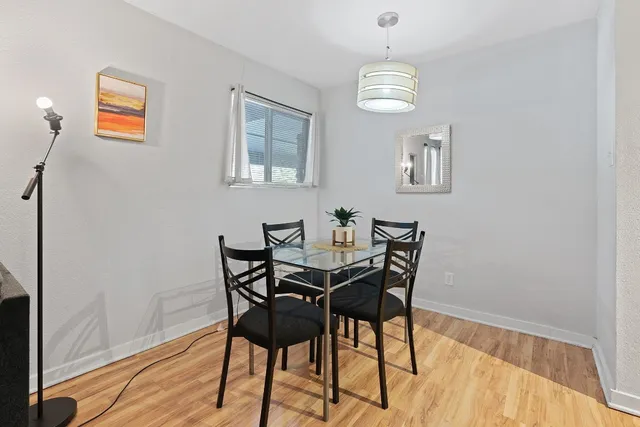 a view of a dining room with furniture and wooden floor