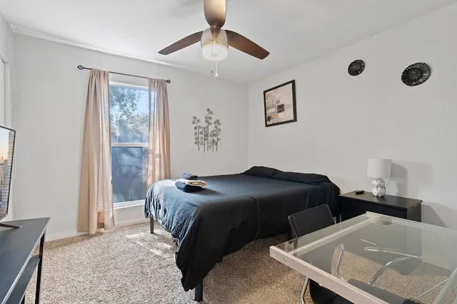 a bedroom with two beds and a window