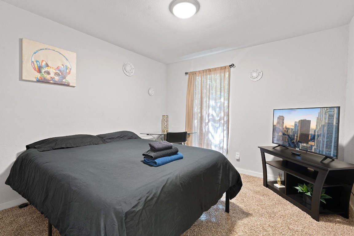 2603 Parker Lane, Unit B Austin, TX 78741 - Photo 40 of 40 a bedroom with a bed and window with lamp