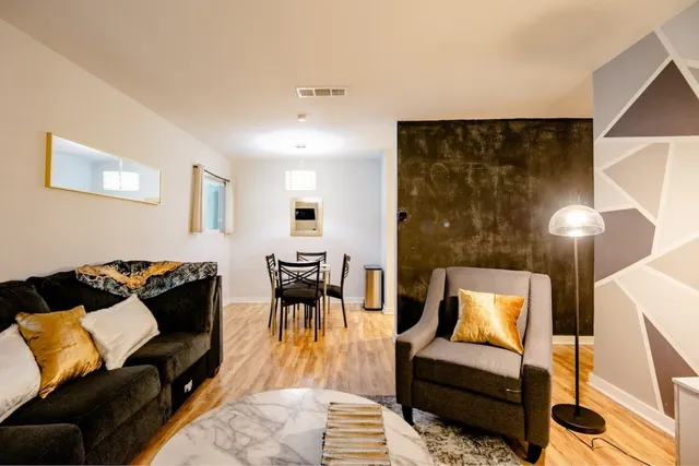 a living room with furniture and a lamp