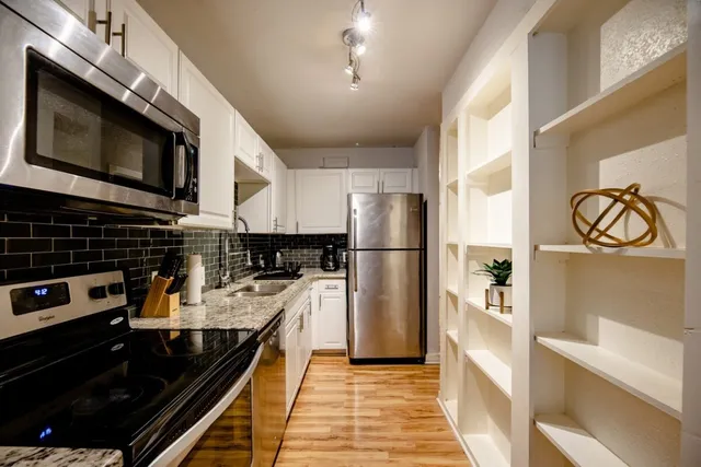 a kitchen with a refrigerator stove and microwave