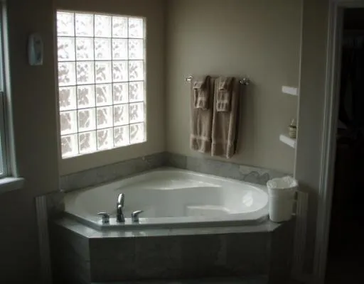 a bath tub sitting in a bathroom next to a window