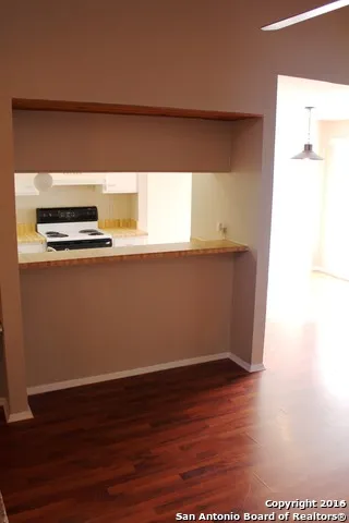 a room with wooden floor and a window