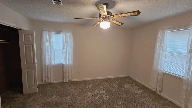 a view of a livingroom with furniture wooden floor and windows