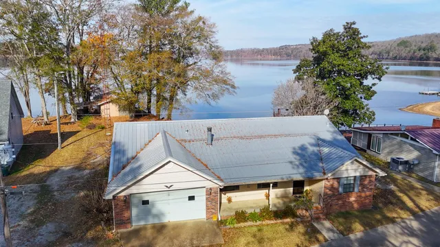 an aerial view of a house with a lake view
